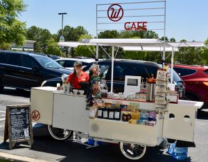 Employee, Carly, sets up the iconic cart at The Landings